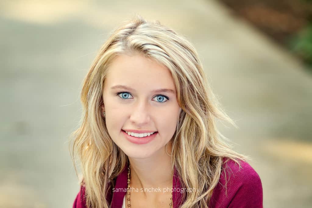 head shot of senior girl on path at ault park