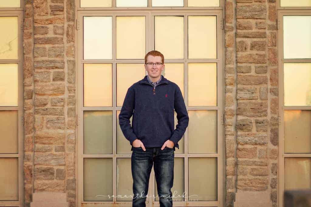 teen senior stands against door at the pavilion at ault park