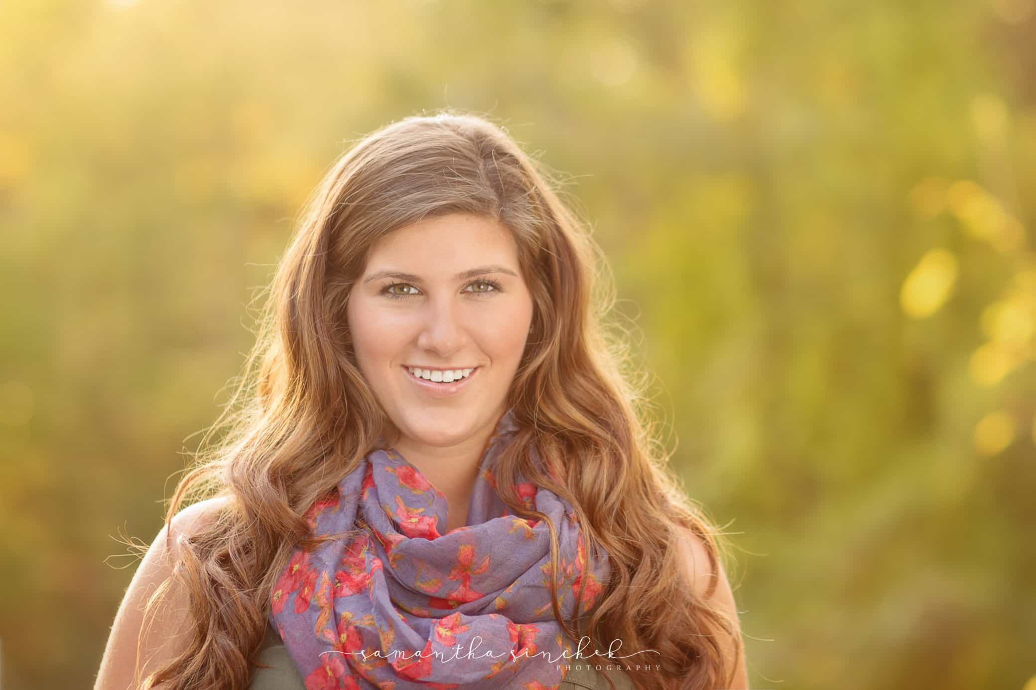 beautiful high school senior bathed in warm fall sunlight at sharon woods