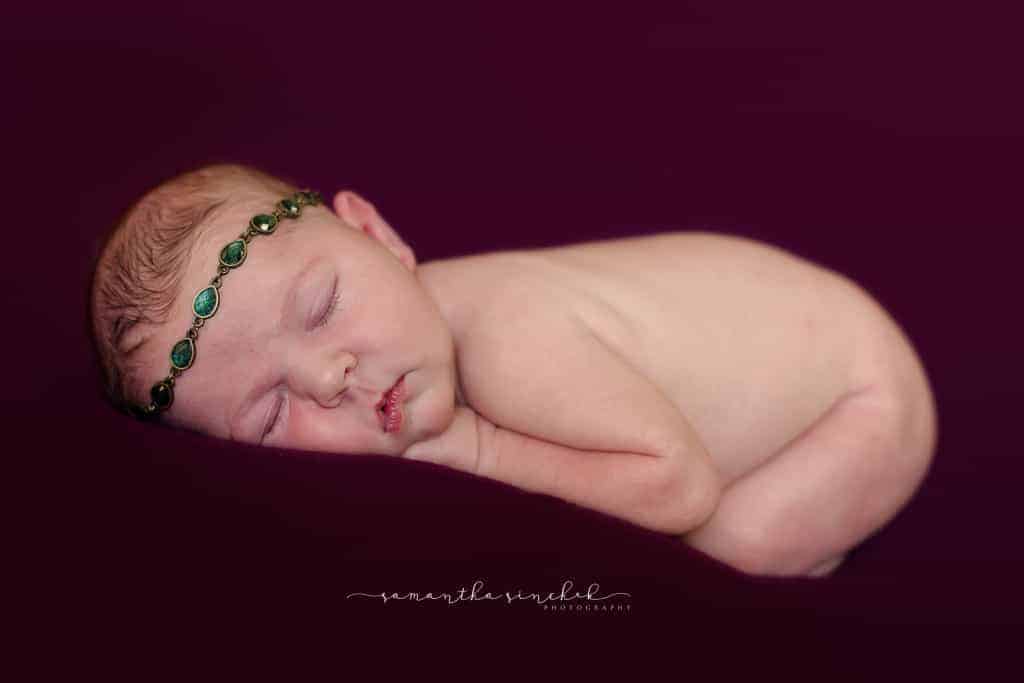 Newborn girl wears jeweled headband at Cincinnati newborn photos