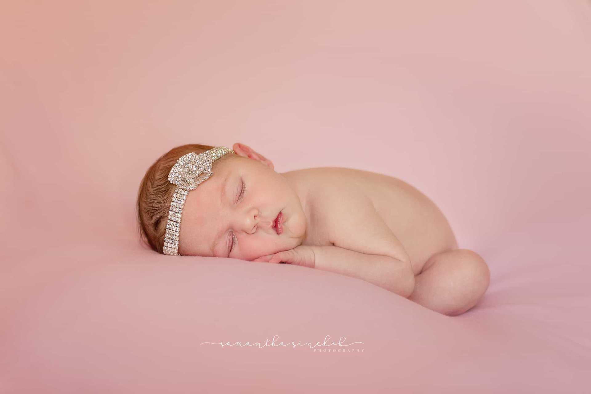 Cincinnati newborn sleeps wearing diamond headband