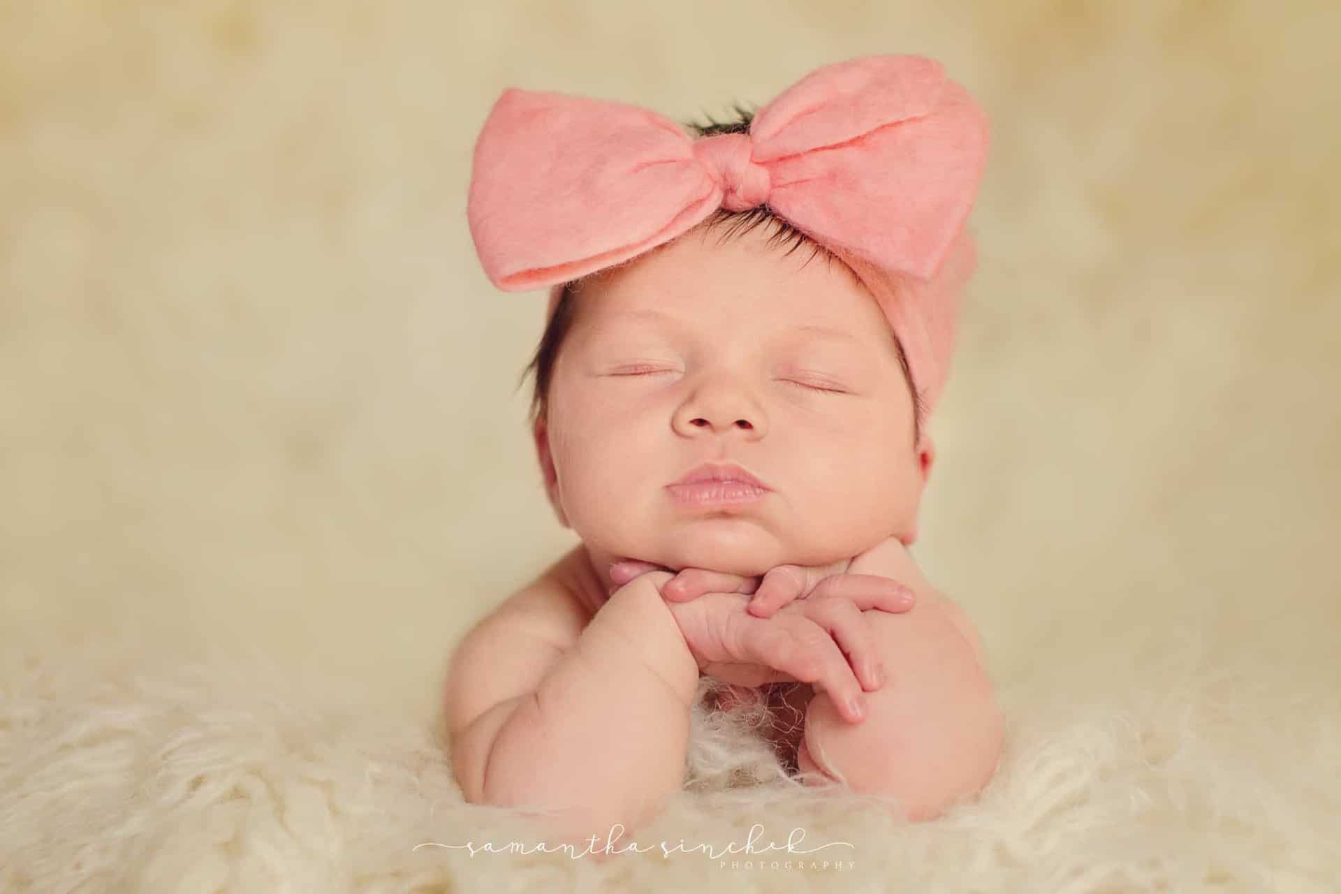 baby girl wears pink headband bow