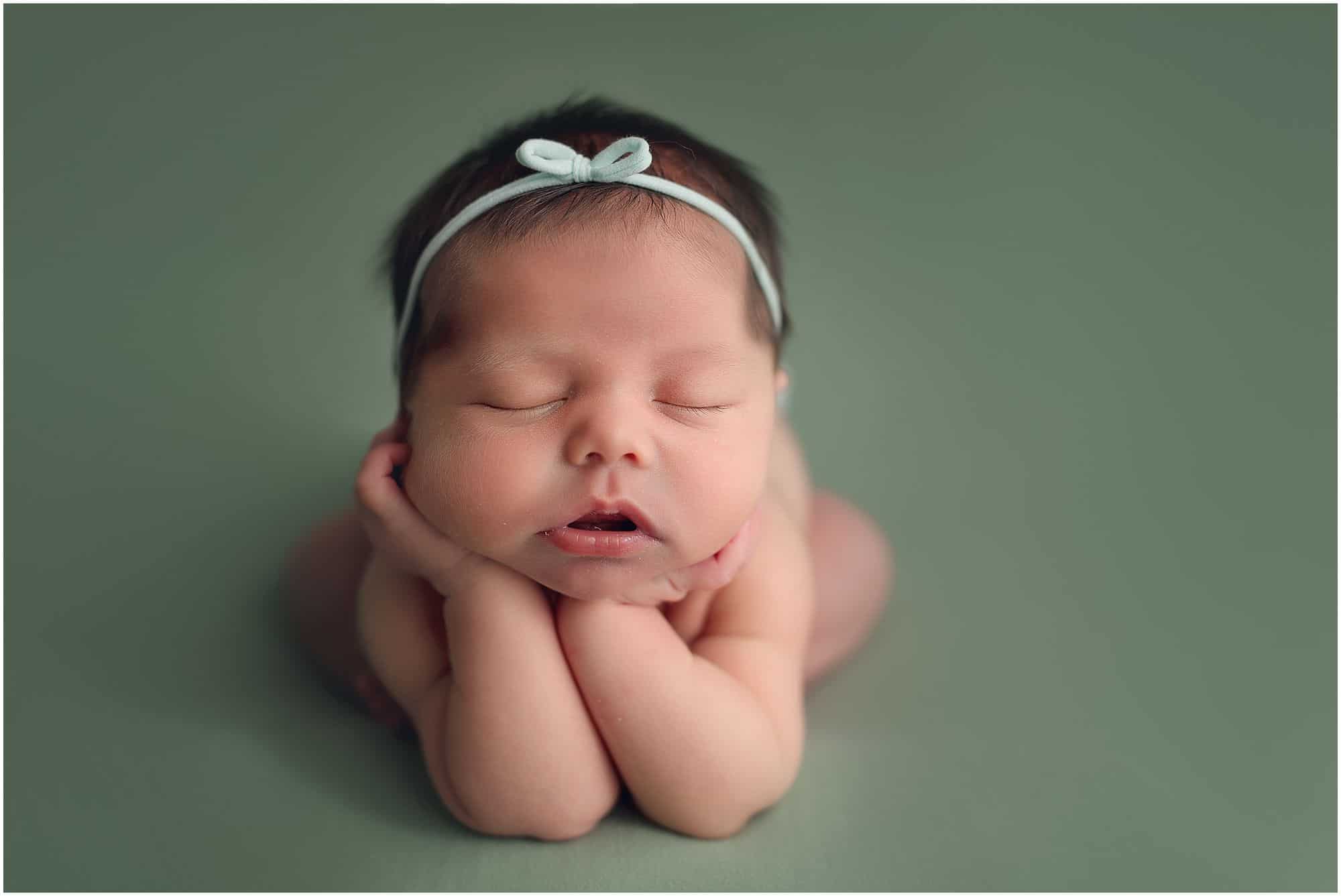 cincinnati newborn photographer Samantha sinchek captures beautiful sleeping baby girl on green