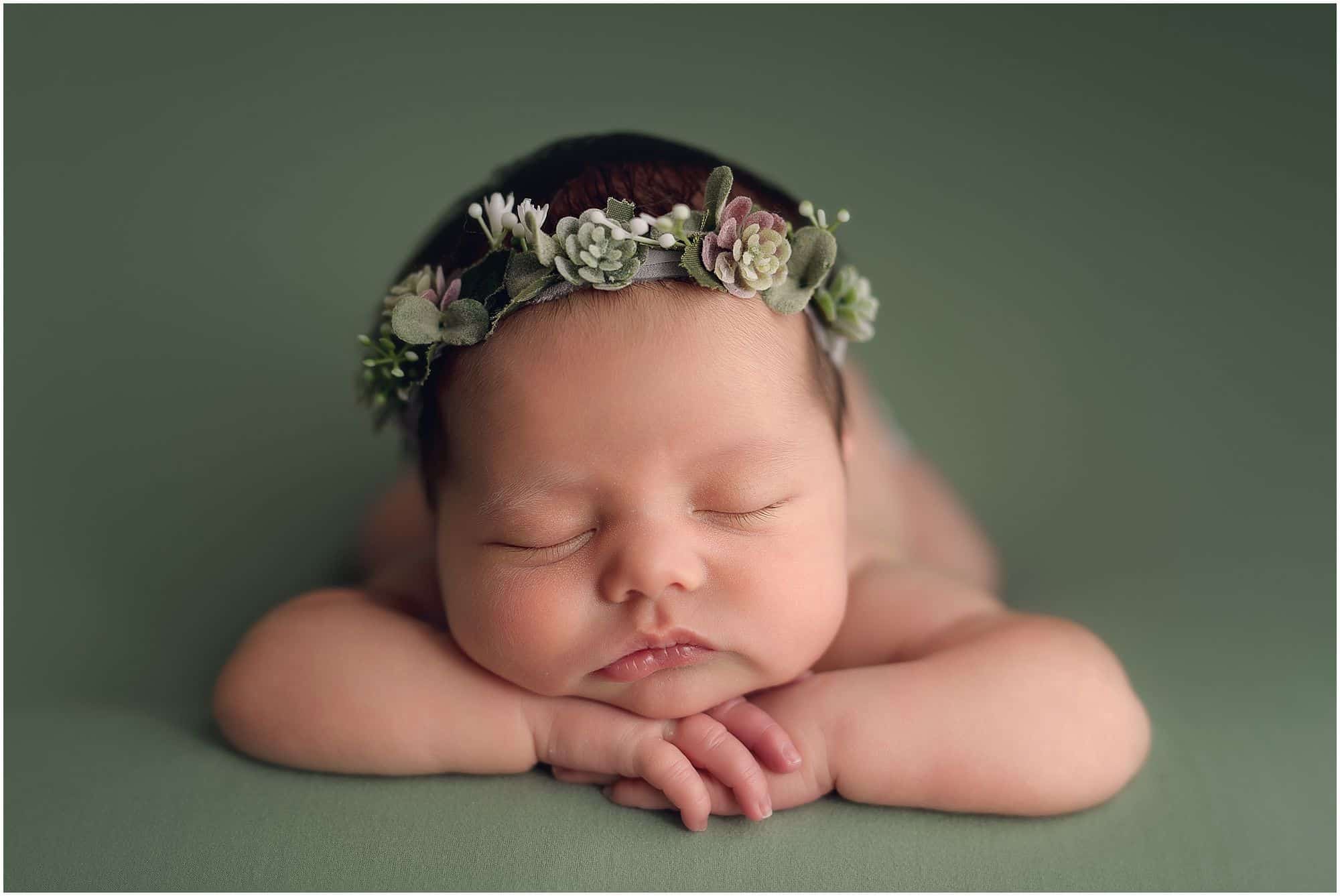 cincinnati newborn photographer Samantha sinchek captures beautiful sleeping baby girl on green