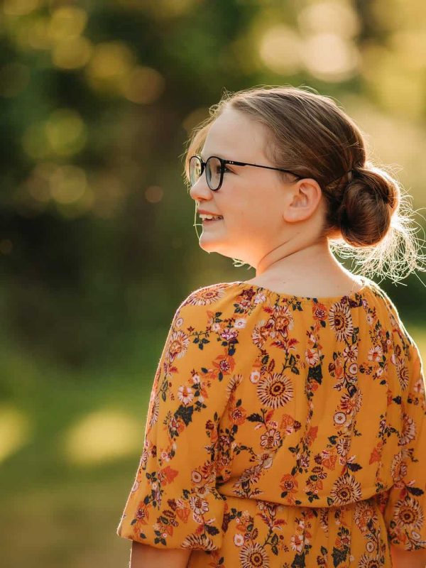 young girl looks off to the side at pictures with Cincinnati's best family photographer Samantha Sinchek photography